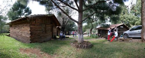 a group of people standing in front of a log cabin at Cabañas los Venados in Mazamitla