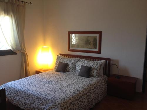a bedroom with a bed with a lamp on it at Dimora La Grazia in Castelvetrano Selinunte