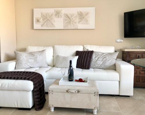 a living room with a white couch and a table at Doñana 1109 in Patalavaca