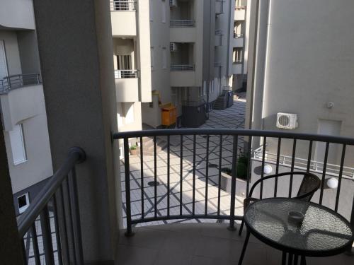 a balcony with a table and a chair in a building at Holiday Wing Apartments in Jagodina