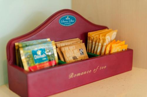 a red container filled with different types of food at Crow's Nest Apartments in Whitianga