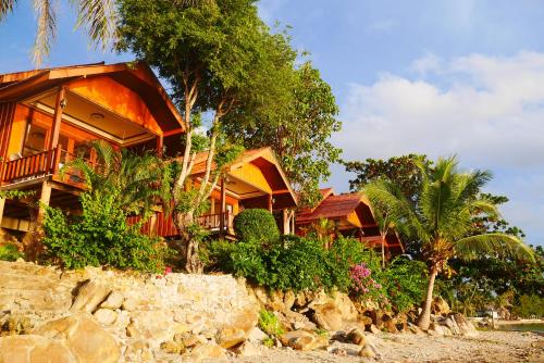 a house on the beach with trees and plants at Zama Resort Koh Phangan in Haad Chao Phao