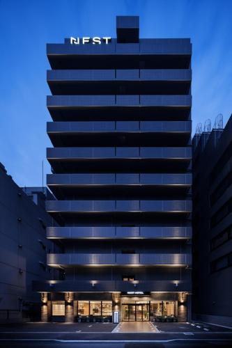 a building with a first sign on the side of it at Nest Hotel Hakata Station in Fukuoka