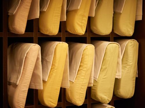 a shelf filled with lots of white towels at Super Hotel Tokyo JR Kamata Nishiguchi in Tokyo