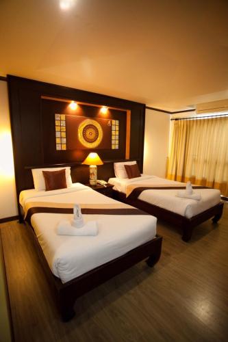Una cama o camas en una habitación de Chour Palace Hotel