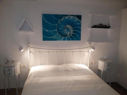 a bedroom with a bed and a painting on the wall at Elia Sea Home in Agios Romanos