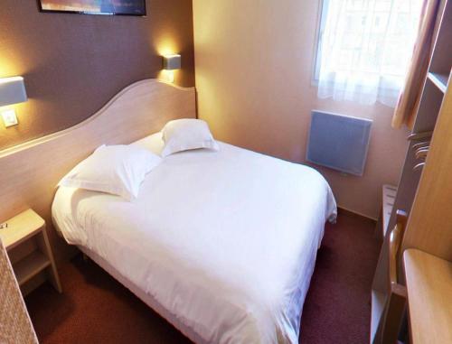a hotel room with a white bed and a window at Logis Hôtel - Le Relais du Parisis in Villeparisis