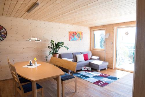 a living room with a couch and a table at Ferienwohnung Feurle´s in Doren