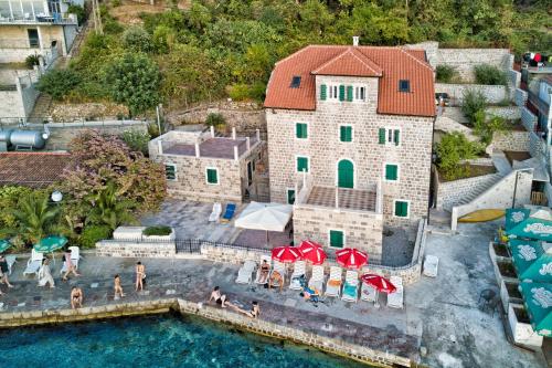 an aerial view of a house with a swimming pool at Apartments Barizon in Lustica