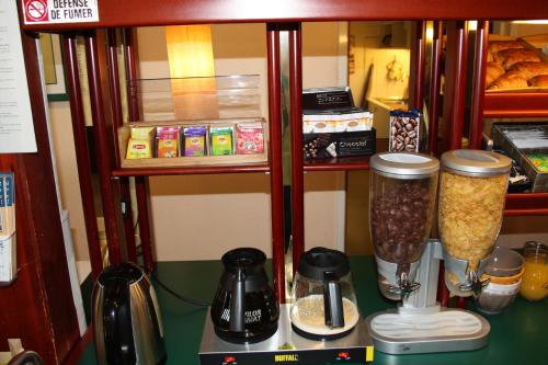 a kitchen with a counter with a blender and food at Hôtel Quick Palace Valence Nord in Bourg-lès-Valence