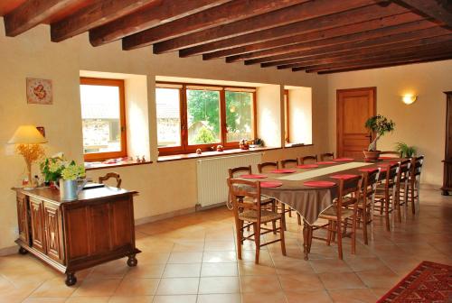 a large dining room with a table and chairs at La Ferme Berger in Les Ardillats