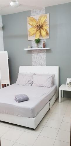 a white bedroom with a white bed in a room at Fahaz Lumut Homestay in Lumut