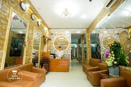 a store with couches and a woman in a mirror at The Queen Hotel & Spa in Hanoi