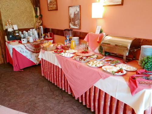 two tables with plates of food on them at Pensjonat Pod Tatrami in Szaflary