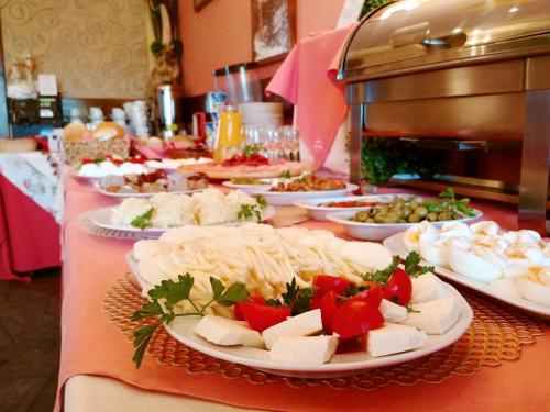 a buffet with plates of food on a table at Pensjonat Pod Tatrami in Szaflary