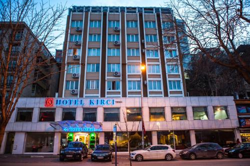 a hotel with cars parked in front of a building at Hotel Kırcı Termal & Spa in Bursa