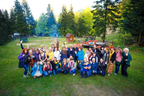 a group of people posing for a picture in a field at Truskavets 365 Hotel in Truskavets