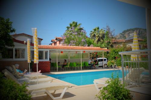 a house with a swimming pool next to a house at Karaca Apart Hotel in Dalyan