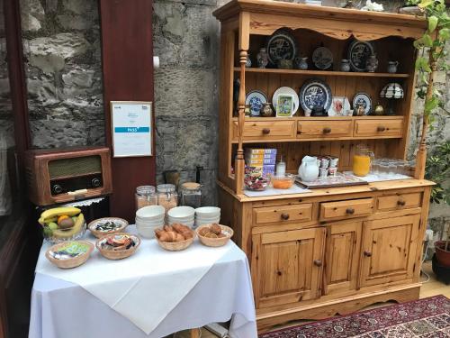 a table with bowls of food on top of it at Clarke Cottage Guest House in Dunfermline