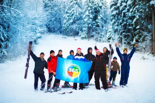 a group of people standing in the snow holding a bfs flag at Truskavets 365 Hotel in Truskavets