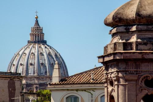 a domed building with a cathedral in the background at MyTALE Apartment Luxury Navona in Rome