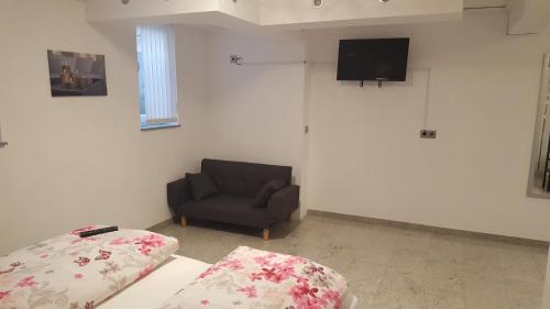 a living room with a couch and a chair at Rust-Fewo-Hotel in Rust