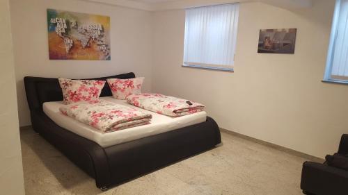 a bed in a room with two pillows on it at Rust-Fewo-Hotel in Rust
