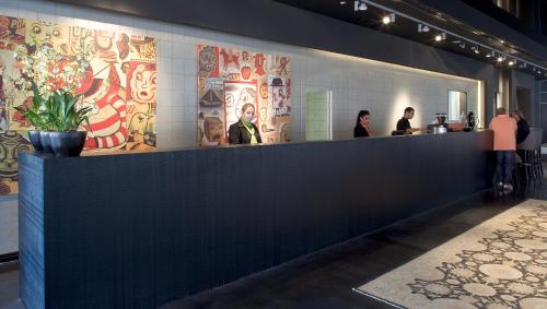 people standing at the counter of a restaurant at Leonardo Boutique Hotel Tel Aviv in Tel Aviv