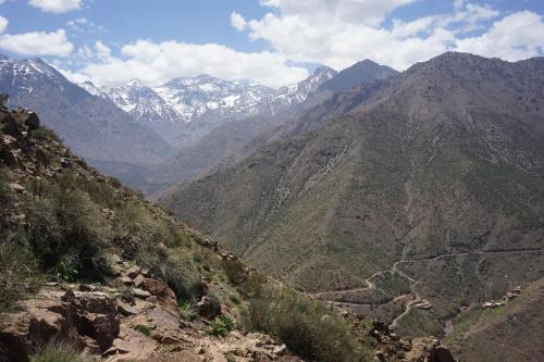 a view of a mountain valley with snow capped mountains at Berber Family Lodge in Imlil