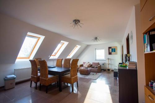 a living room with a dining room table and chairs at Marilyn Apartman Gyenesdiás in Gyenesdiás