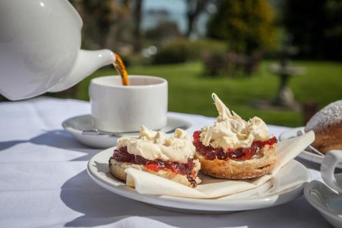 a plate with two desserts and a cup of coffee at The Hotel Balmoral - Just for Adults in Torquay