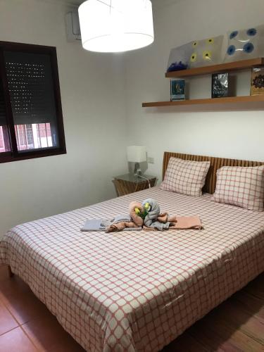 a bed with a stuffed animal on top of it at Lancelot in Puerto Rico de Gran Canaria