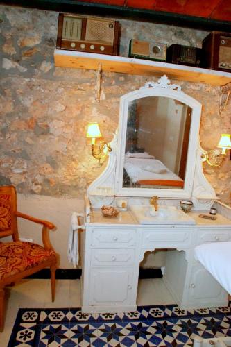 a bathroom with a white sink and a mirror at Sitges Royal Rooms in Sitges