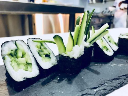 four sushi rolls with broccoli in them on a table at Novotel Jazan in Jazan