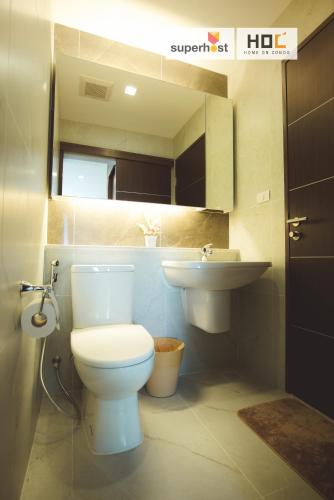 a bathroom with a toilet and a sink at The Astra Condo by Ping in Chiang Mai