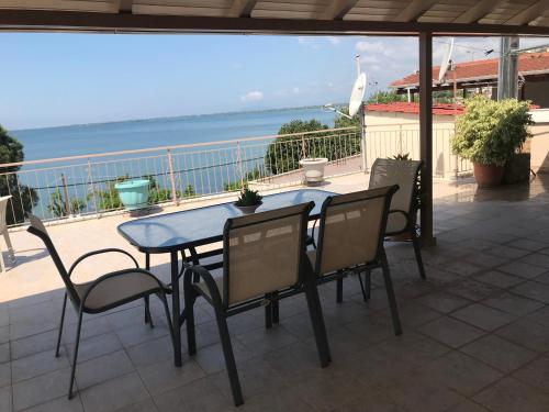 a table and chairs on a patio with a view of the ocean at Corali in Menídion