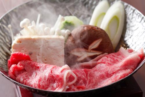 a bowl of food with meat and fruit in it at Terakoya Hanatei in Asago