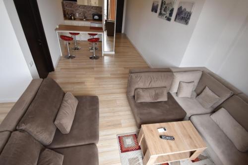 a living room with a brown couch and a table at SaBa Apartments in Old Tbilisi in Tbilisi City