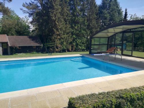 a swimming pool with a gazebo next to a house at La Bergerie de Lives in Namur