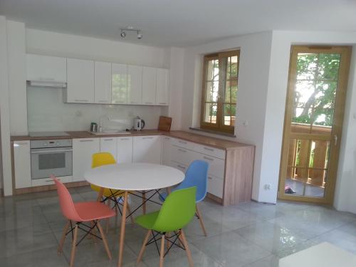 a kitchen with a table and four chairs at apartament in Szklarska Poręba