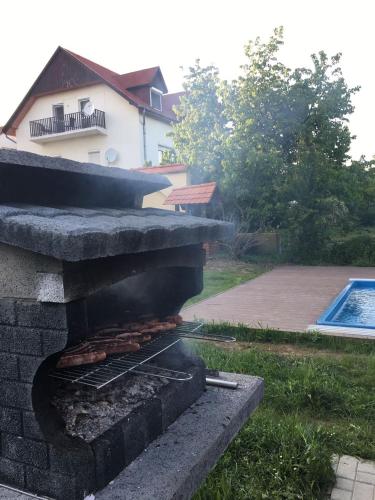 a barbecue grill with food on top of it at Arina Villa in Hévíz