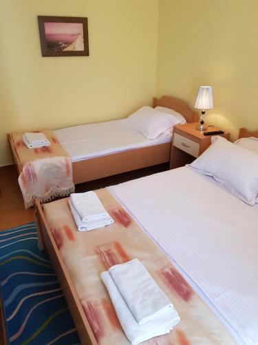 a room with two beds with towels on them at Apartments Tamara in Budva