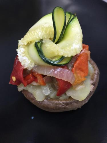 a bagel sandwich with vegetables on a table at Gran Hotel Ciudad de Barbastro in Barbastro