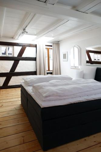 a bedroom with a large bed in front of a window at Fachwerkhaus Maximilian in Speyer