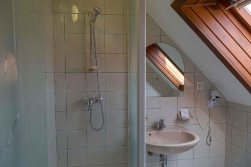 a bathroom with a shower and a sink at Arina Villa in Hévíz