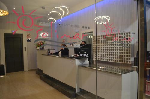 a restaurant with red graffiti on the wall and a counter at Hotel Apartamentos Solimar in Calafell