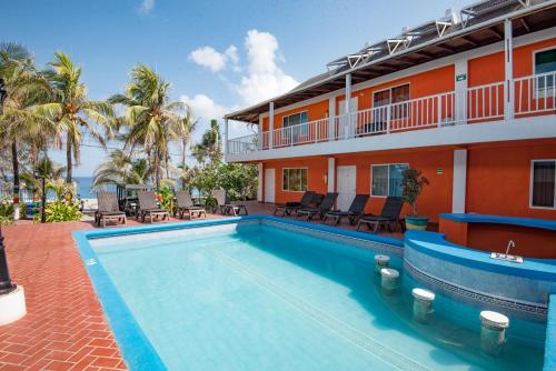a swimming pool in front of a building at Sunset Hotel in San Andrés