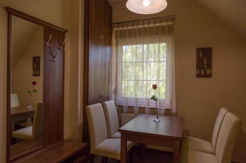a room with a table and chairs and a window at Arina Villa in Hévíz