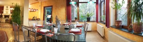 a dining room with a glass table and chairs at Cristalex Villaverde Bucharest in Bucharest