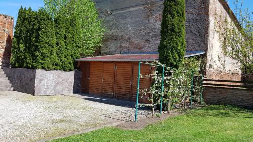 a building with a gate in front of a garage at Penzion U Vlků in Valtice